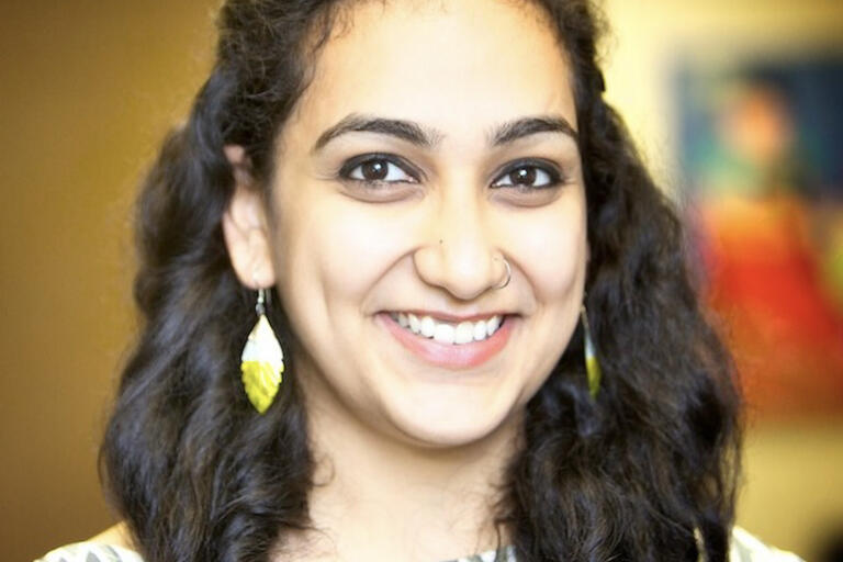 a female graduate student  headshot, nicely smiling at you