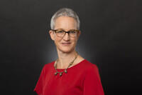 a female scholar wearing red top with glasses